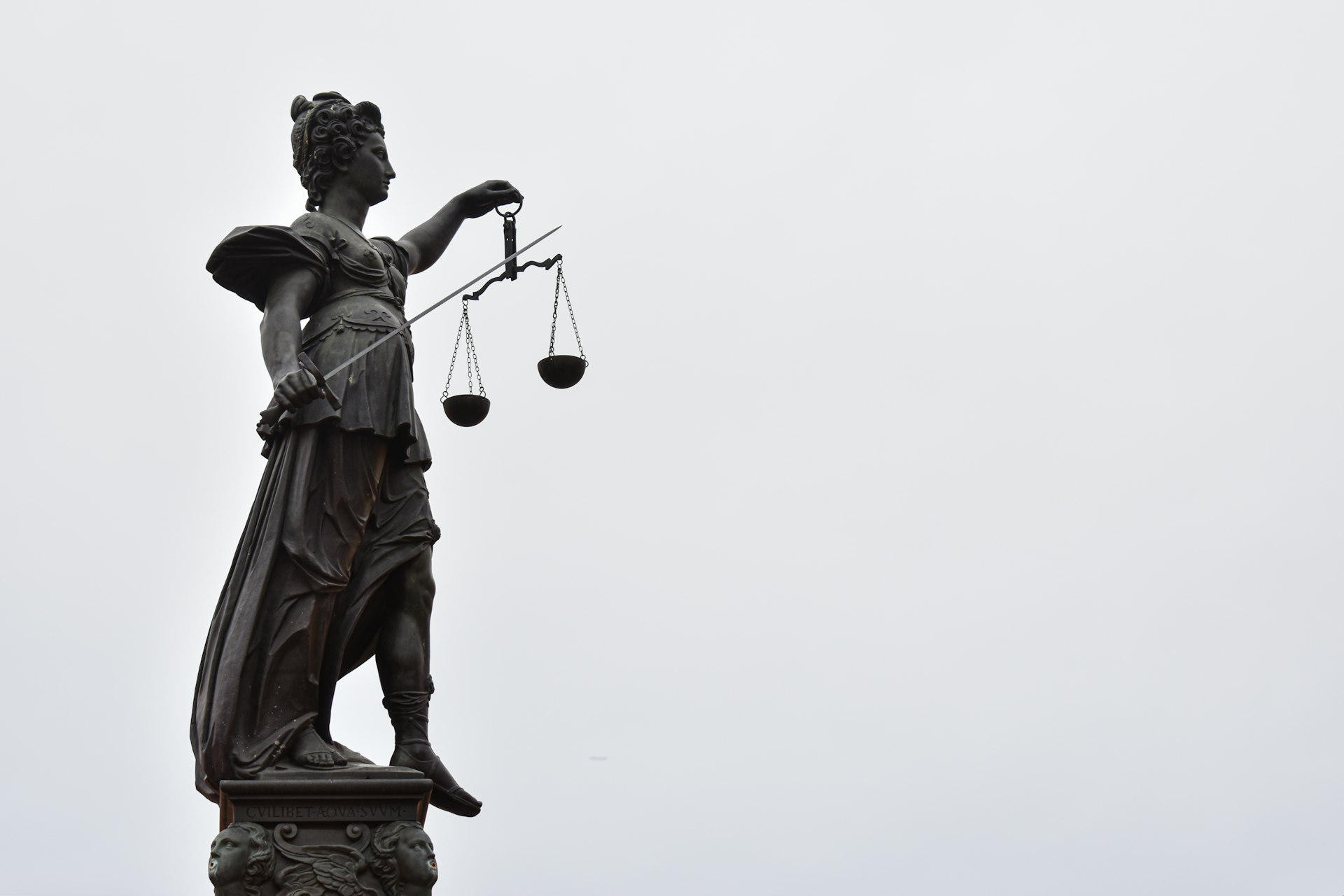 A statue of lady justice holding a scale of justice